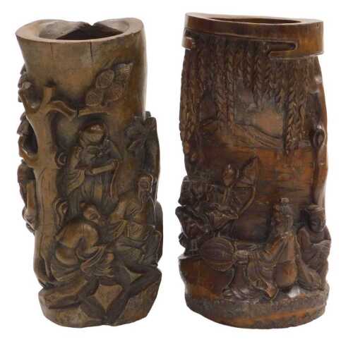 A 20thC Chinese carved bamboo brush pot, decorated in high relief with two figures seated upon...