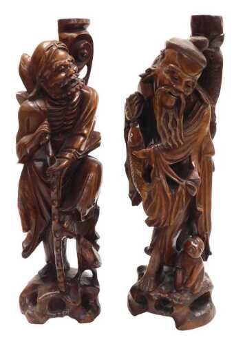 Two late 19thC Chinese hardwood figural carved table lamps, lacking fitments, both carved as...