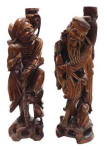 Two late 19thC Chinese hardwood figural carved table lamps, lacking fitments, both carved as...