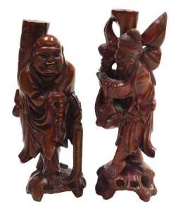 Two late 19thC Chinese hardwood figural carved table lamps, lacking fitments, both carved as...