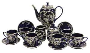 A Chinese cobalt blue pottery coffee service, with white metal overlay of dragons chasing...