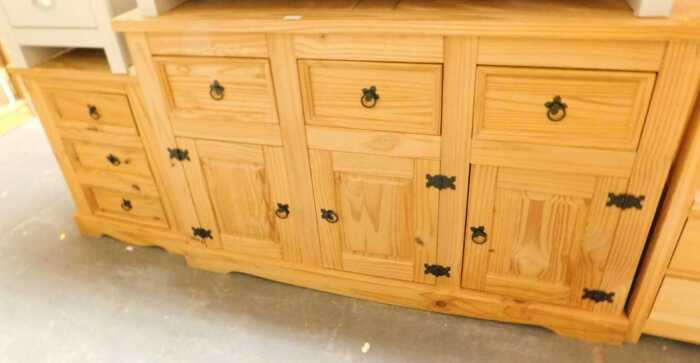 A pine sideboard, with three doors above three panelled cupboards, raised on bracket feet,...