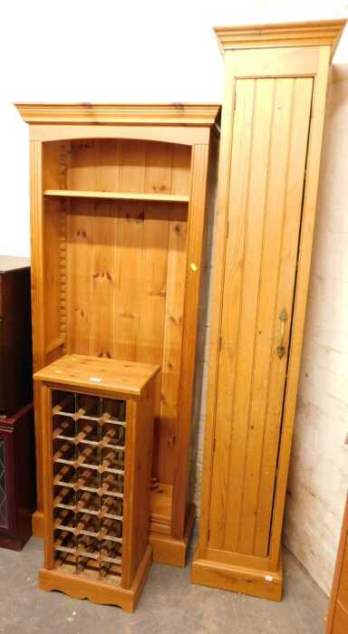 A group of pine furniture, comprising a wine rack with metal sections, raised on bracket feet,...