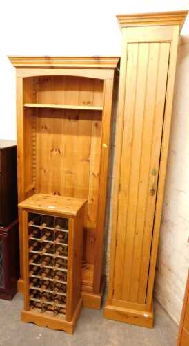 A group of pine furniture, comprising a wine rack with metal sections, raised on bracket feet,...