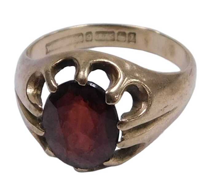 A 9ct gold and single red stone ring, claw set, size P&frac12;, 4.6g.