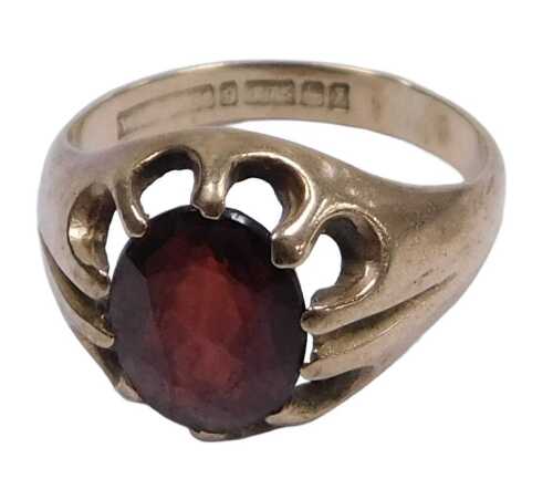 A 9ct gold and single red stone ring, claw set, size P&frac12;, 4.6g.