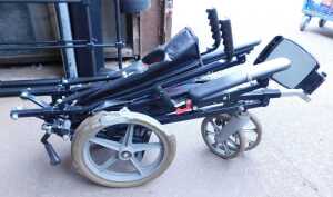 A folding wheelchair.