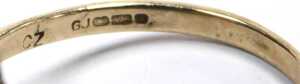 A 9ct gold lozenge shaped ring, set with czs and three tiny green stones, with splayed shoulders,... - 3