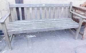 A teak garden bench, with a slatted seat and backrest, 145cm wide.