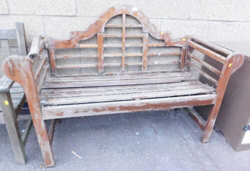 A teak garden bench, with a moulded arched back and slatted seat, 130cm wide, (AF), together...