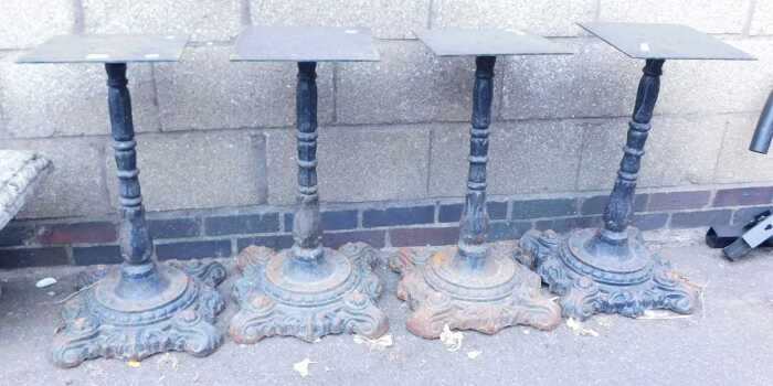 A set of four late Victorian cast iron table bases, probably from pub tables, with scrolling...
