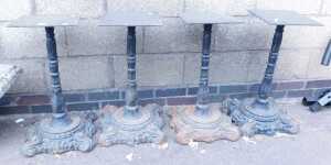 A set of four late Victorian cast iron table bases, probably from pub tables, with scrolling...