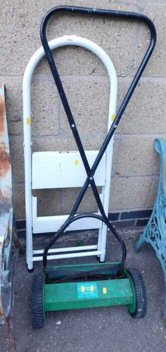 A push mower, PPM35, together with a white enamelled two-step step ladder.