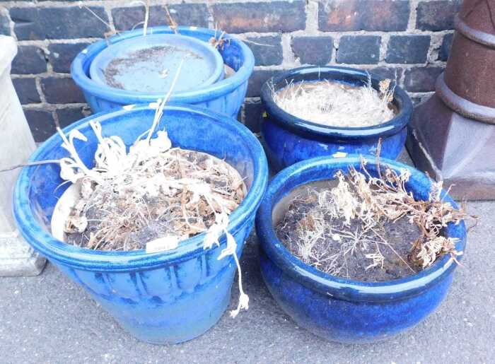Blue glazed plant pots, comprising two pairs and one base.