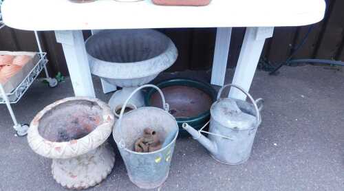 Plant pots, together with a galvanised bucket and watering can, and a plastic garden table.