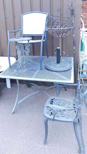 Decorative garden furniture, to include a table, chairs, a rose pattern sundial, rose pattern...