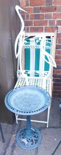 Green and white striped deckchairs, together with a birdbath, garden side table and shelves,...