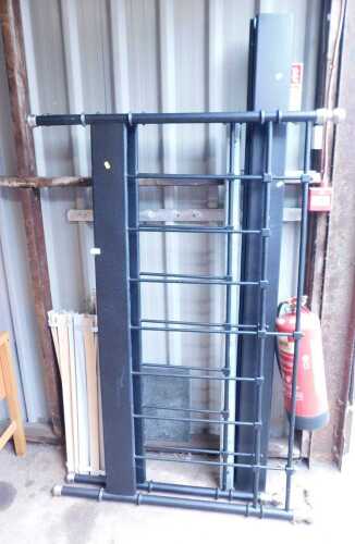 A black metal framed double bed, comprising headboard, footboard, side rails, and slats.