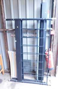 A black metal framed double bed, comprising headboard, footboard, side rails, and slats.