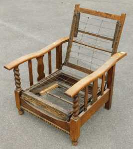 An early 20thC oak adjustable armchair, lacking cushions.