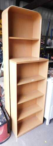 Two open bookcases, one with a rounded top.