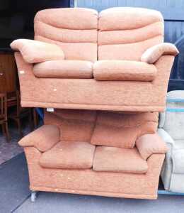 A pair of G-Plan terracotta upholstered two seater sofas.