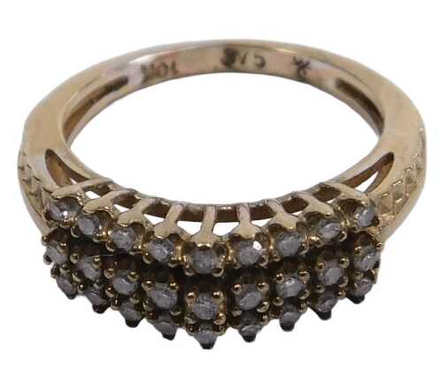 A diamond three row ring, set with eighteen brilliant cut diamonds in a high claw arched design,...