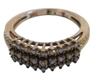 A diamond three row ring, set with eighteen brilliant cut diamonds in a high claw arched design,...