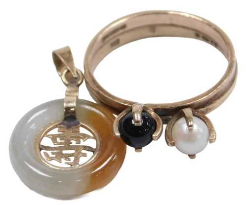 A 9ct gold and pearl two stone ring, set with black and white seed pearls, each in a claw...