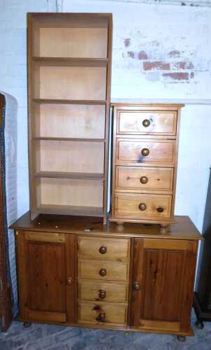 A pine sideboard, with four central drawers, flanked by two panelled cupboards, raised on turned...