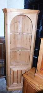 A 20thC waxed pine corner cabinet, the top with a moulded pediment above two shaped shelves,...