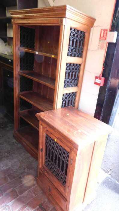 A mangowood open bookcase, with pierced wrought metal side panels, 180cm high, 97cm wide, 40cm...
