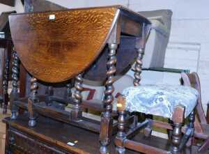An oak gate leg table, 84cm wide, together with an oak framed stool, with an overstuffed seat. (2)