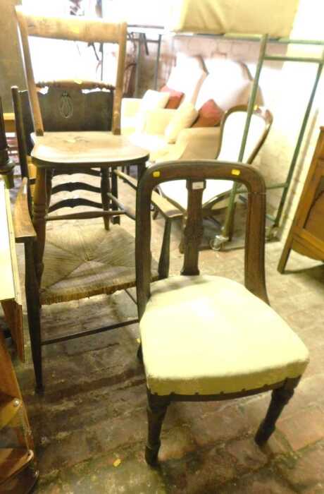 An Arts and Crafts style oak dining chair, with a rush seat, together with an elm country made...