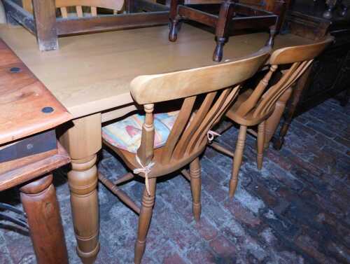 A beech dining table, the rectangular top raised on turned legs, 73cm high, the top 130cm x 75cm,...