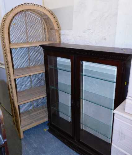A mahogany display cabinet, the glass fronted doors enclosing glass shelves, above three small...