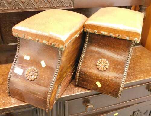 A pair of oak fireside coal boxes, each with a brown leatherette top one enclosing a tin liner,...
