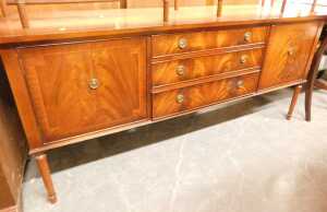 A mahogany and crossbanded extending dining table, raised on twin pedestals with sabre legs,... - 2