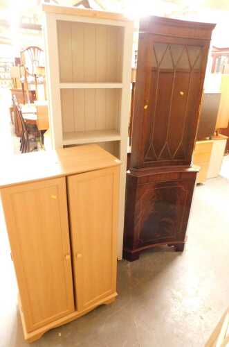 A group of furniture, comprising a mahogany corner cabinet, a pale grey painted open bookcase,...