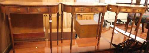Three Regency style mahogany side tables, each with two frieze drawers, raised on slender...