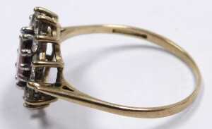 A 9ct gold garnet and cz ring, the oval cut garnet in a surround of brilliant cut czs, in a claw... - 2