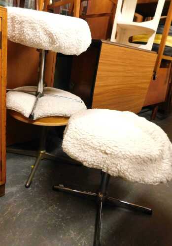 A set of three industrial style stools, each with a revolving circular seat raised on an...