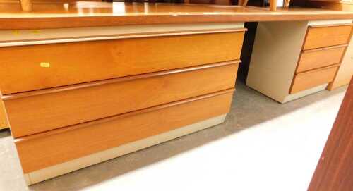 A 1970s teak sideboard, with three draws to the base, flanked by a recess and three further...