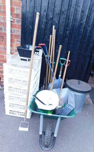 Gardening equipment, to include a plastic wheelbarrow, gardening tools, a galvanised steel...