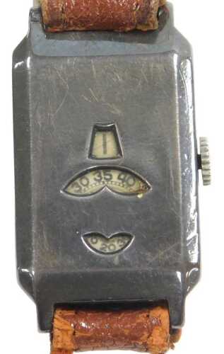 A 1930s silver cased jump hour mechanical wristwatch, displaying hours, minutes and seconds,...