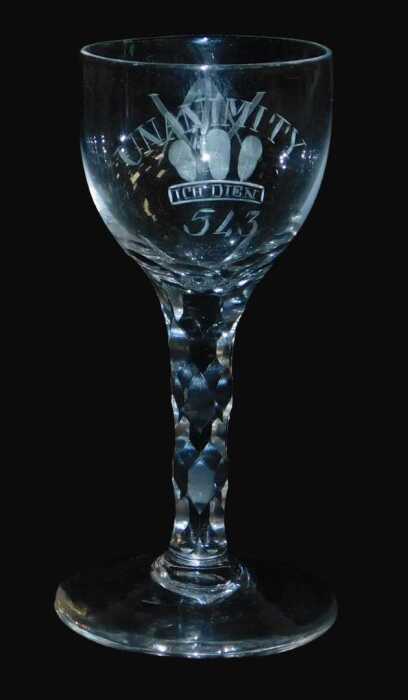 A late 18thC Masonic wine glass, the ovoid bowl engraved with Unanimity, above Prince of Wales...