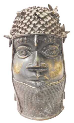 An African Nigerian Benin tribal bronze bust of a warrior, wearing a headdress, 33cm high.