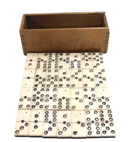 A set of 19thC bone and ebony dominoes, boxed.