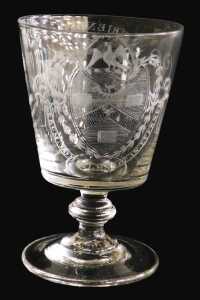 An early 19thC Georgian glass rummer, the bucket shaped bowl engraved with an oval cartouche of...