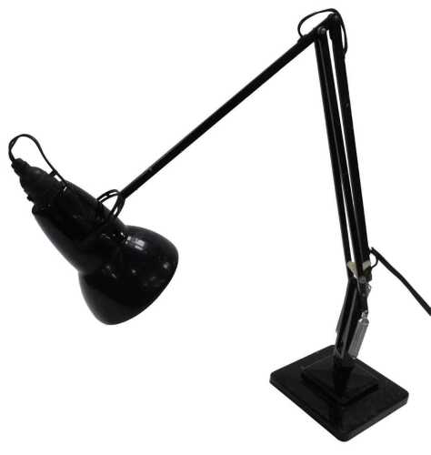 A Herbert Terry & Sons Ltd black angle poise table lamp, raised on stepped square base.